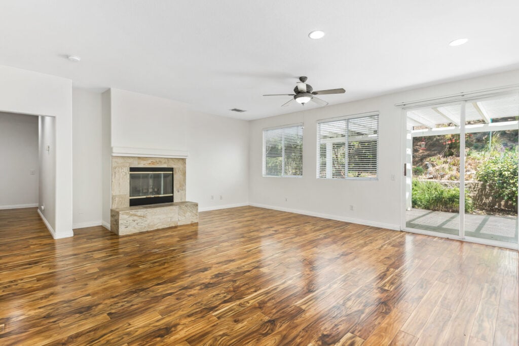 Living room with fireplace and open layout in Chapman Heights home — DeBonis Real Estate Team]