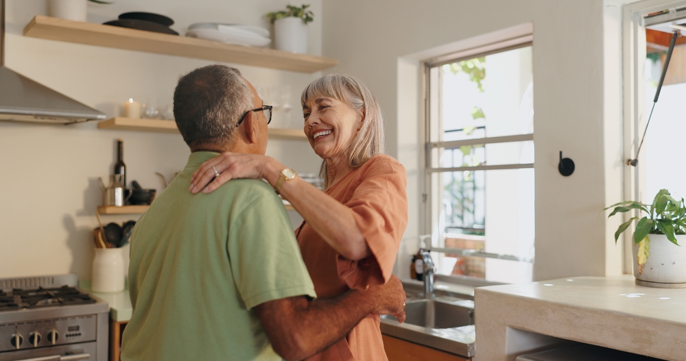 Couple in the bright, open kitchen of a single-story 55+ home in Beaumont