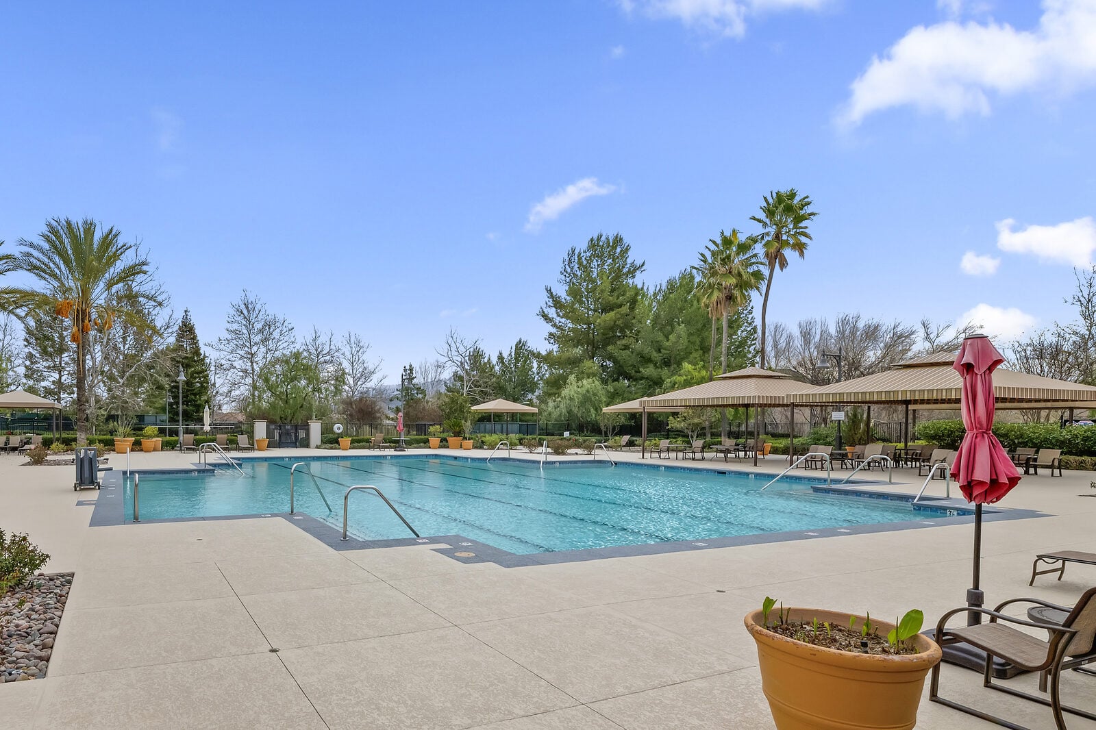Resort-style outdoor pool with shade umbrellas at Four Seasons at Beaumont