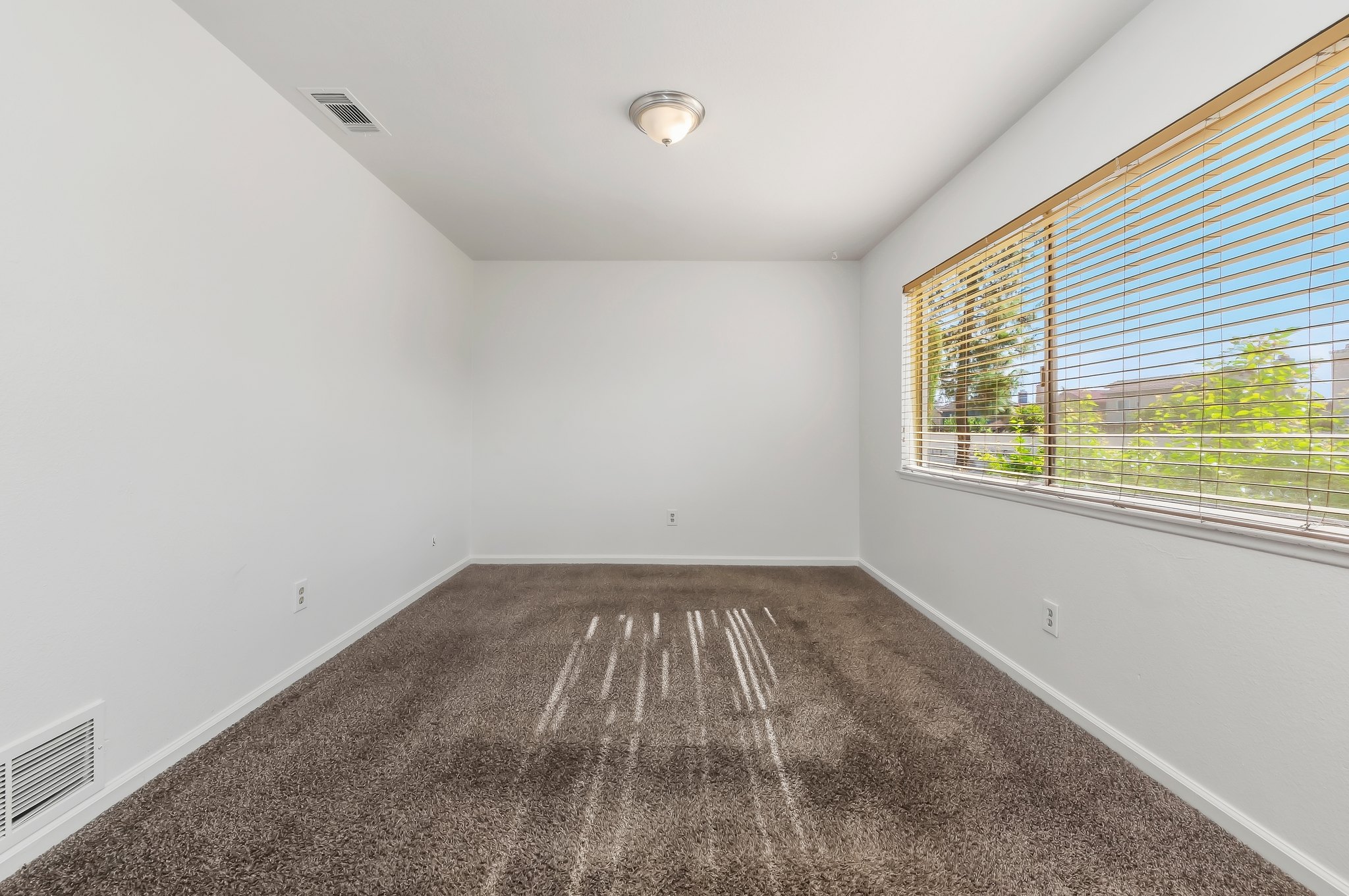 Second carpeted bedroom with large window | 1194 Border Ave #A, Corona