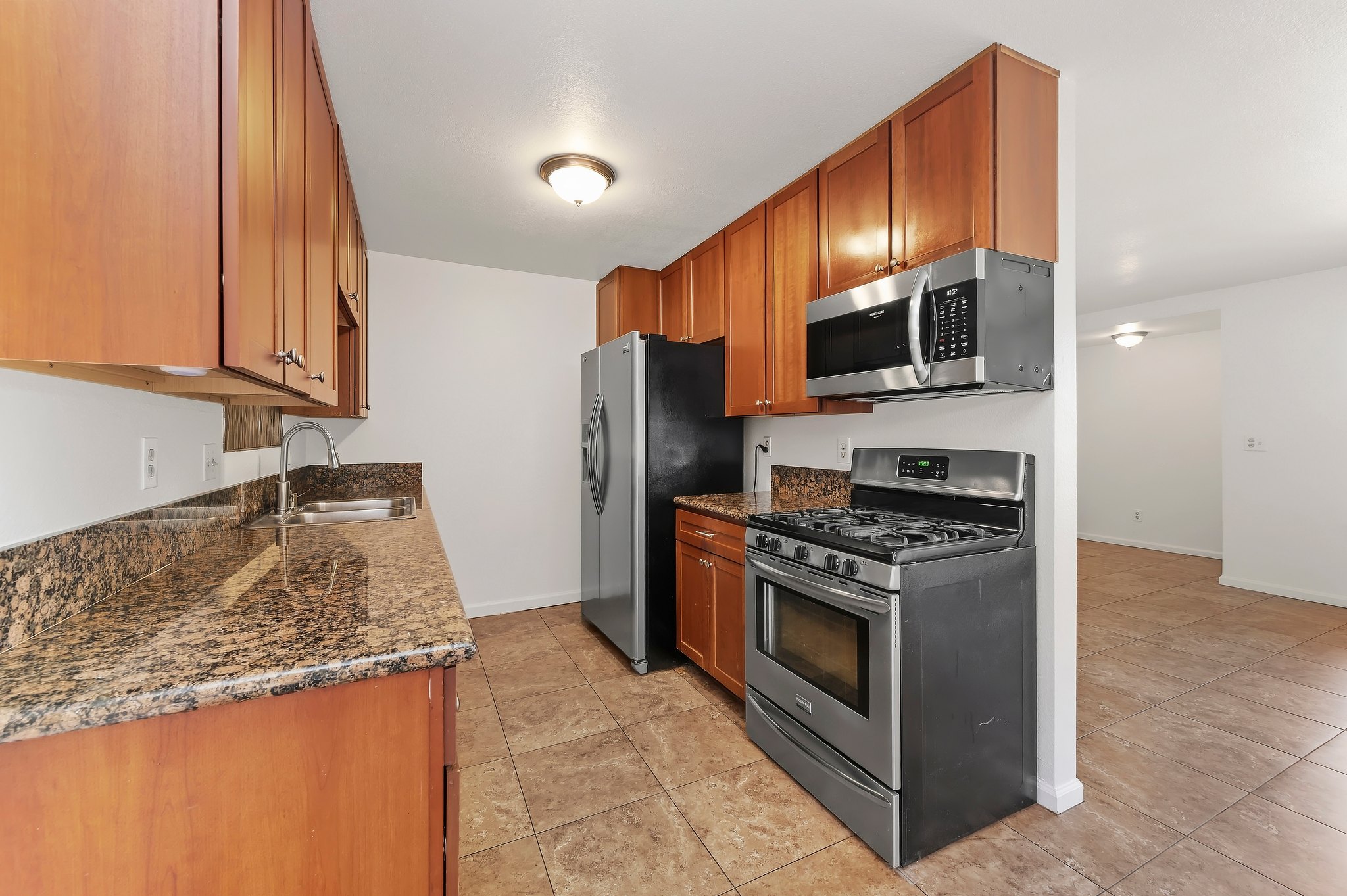 Kitchen with granite counters and stainless appliances | 1194 Border Ave #A, Corona