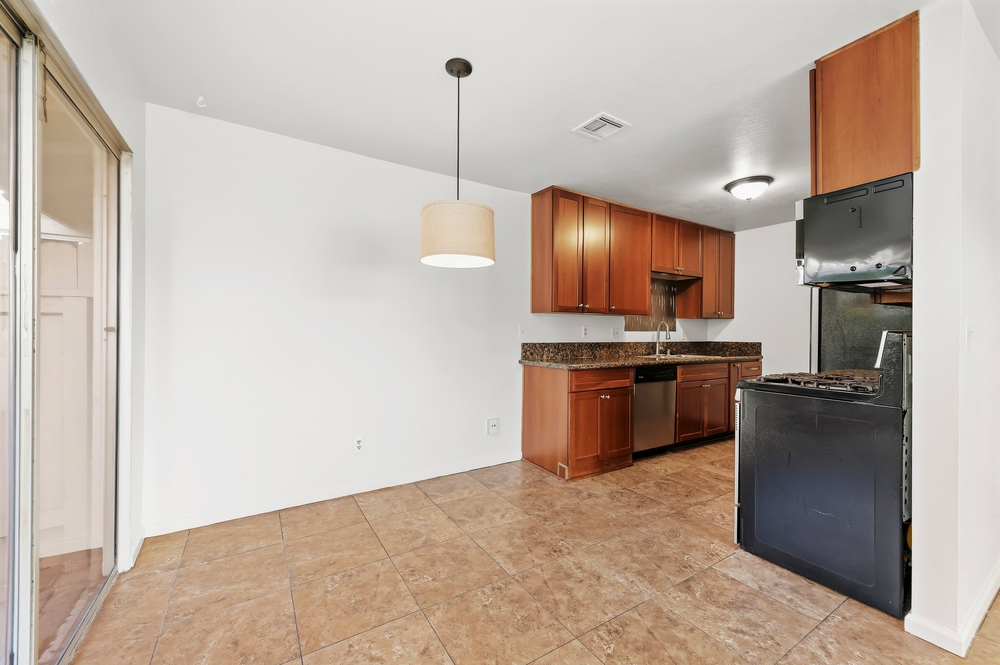 Kitchen with wood cabinets opening to the dining area | 1194 Border Ave #A, Corona