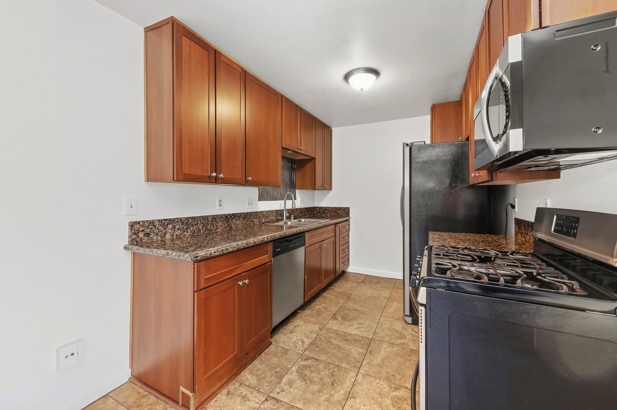 Upgraded kitchen with granite countertops and wood cabinets | 1194 Border Ave #A, Corona