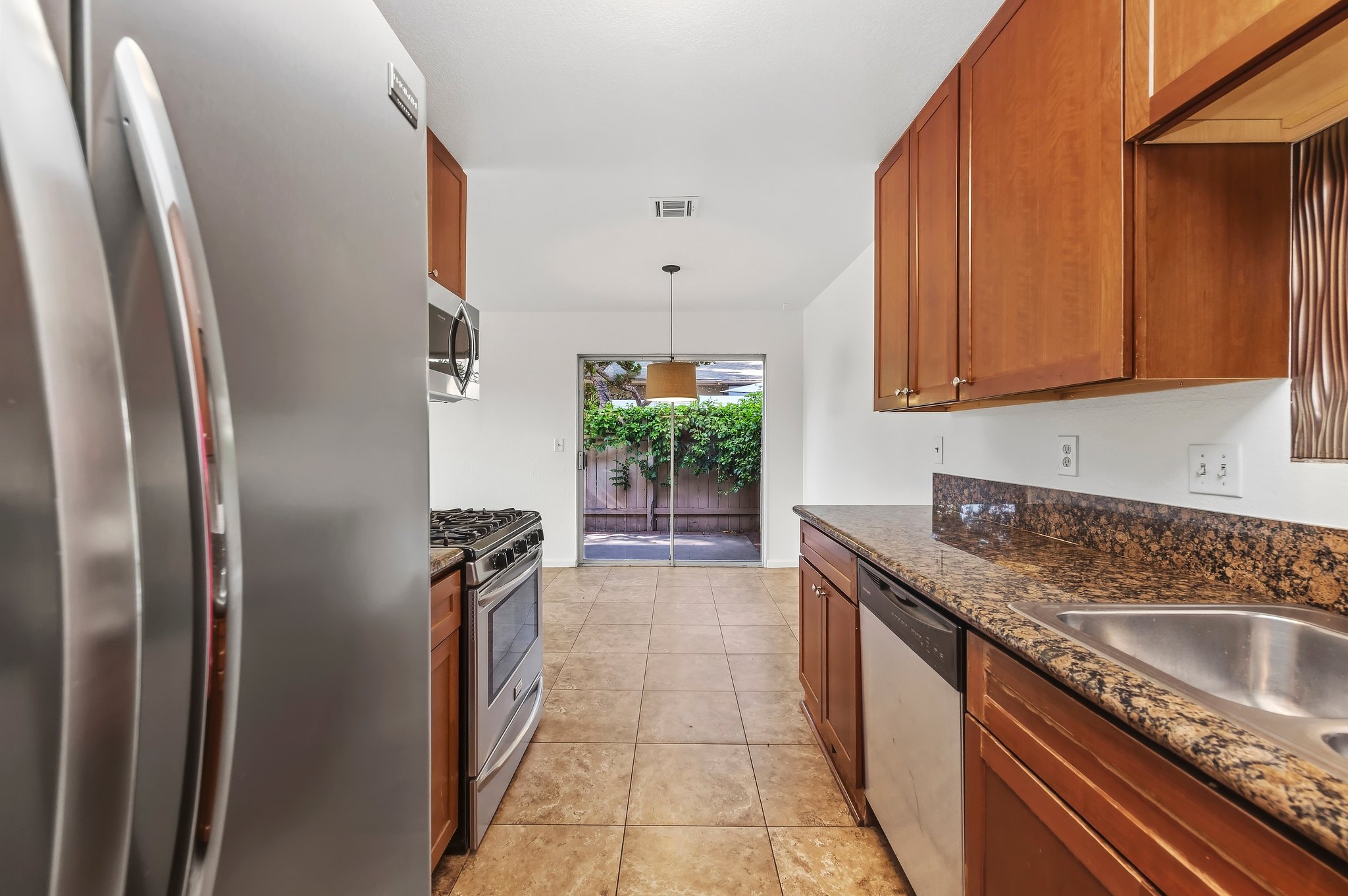 Kitchen looking toward the dining area and patio slider | 1194 Border Ave #A, Corona