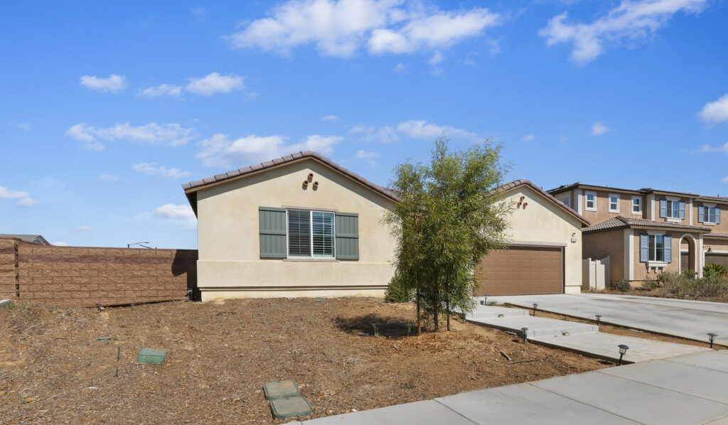 Corner-lot view of the front elevation at 14016 Liguria, Beaumont