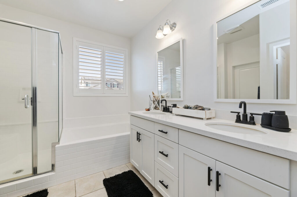 Primary bathroom with dual sinks and quartz counters