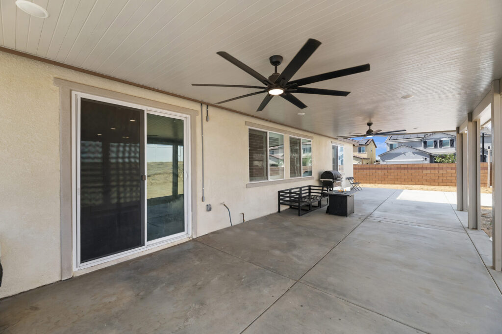 Covered patio with a large ceiling fan