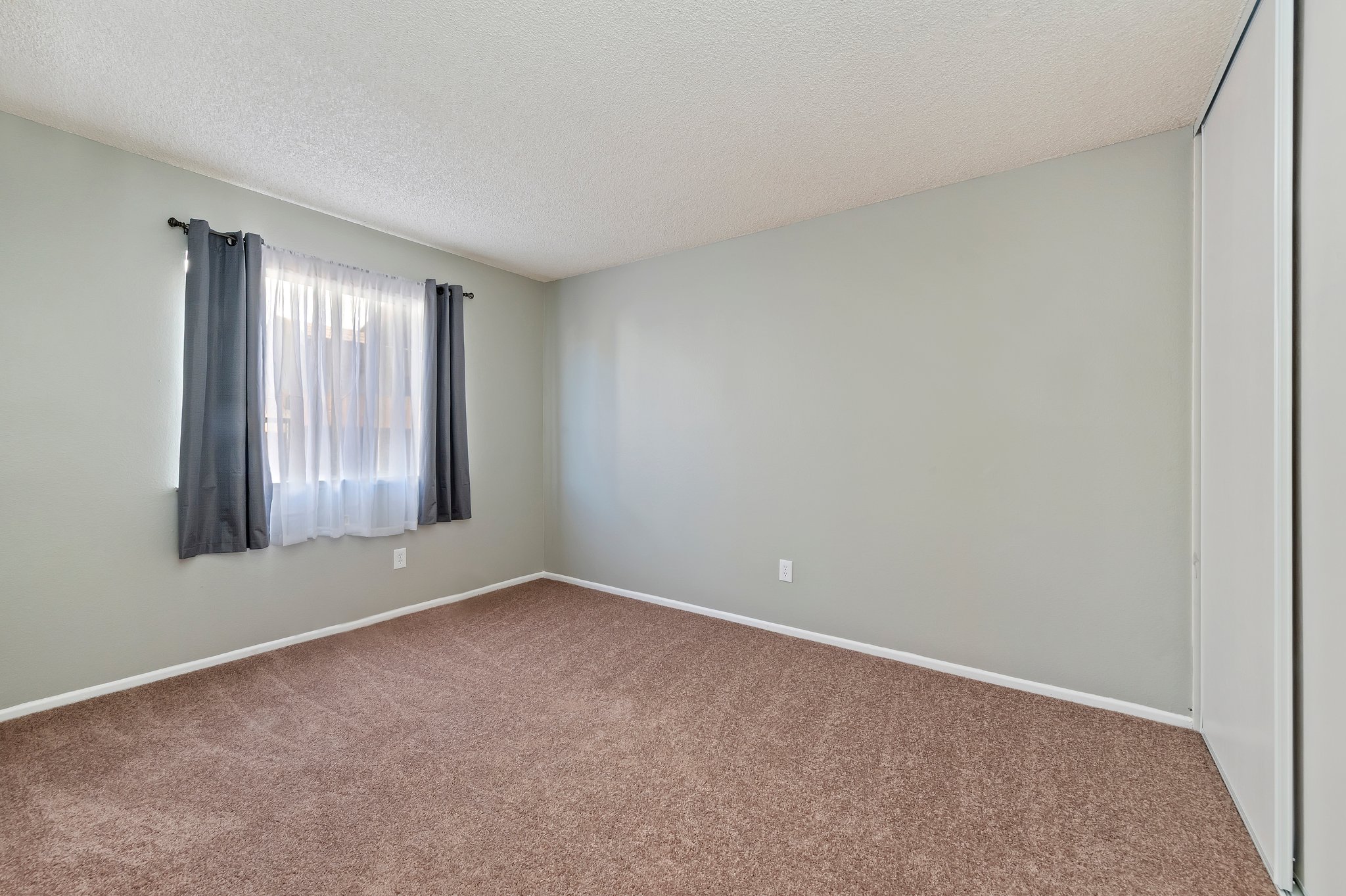 Bedroom with carpet and window | 14927 Wintergreen St, Moreno Valley