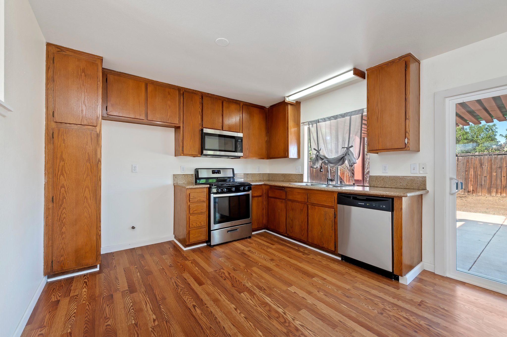 Kitchen with wood cabinets and stainless appliances | 14927 Wintergreen St, Moreno Valley