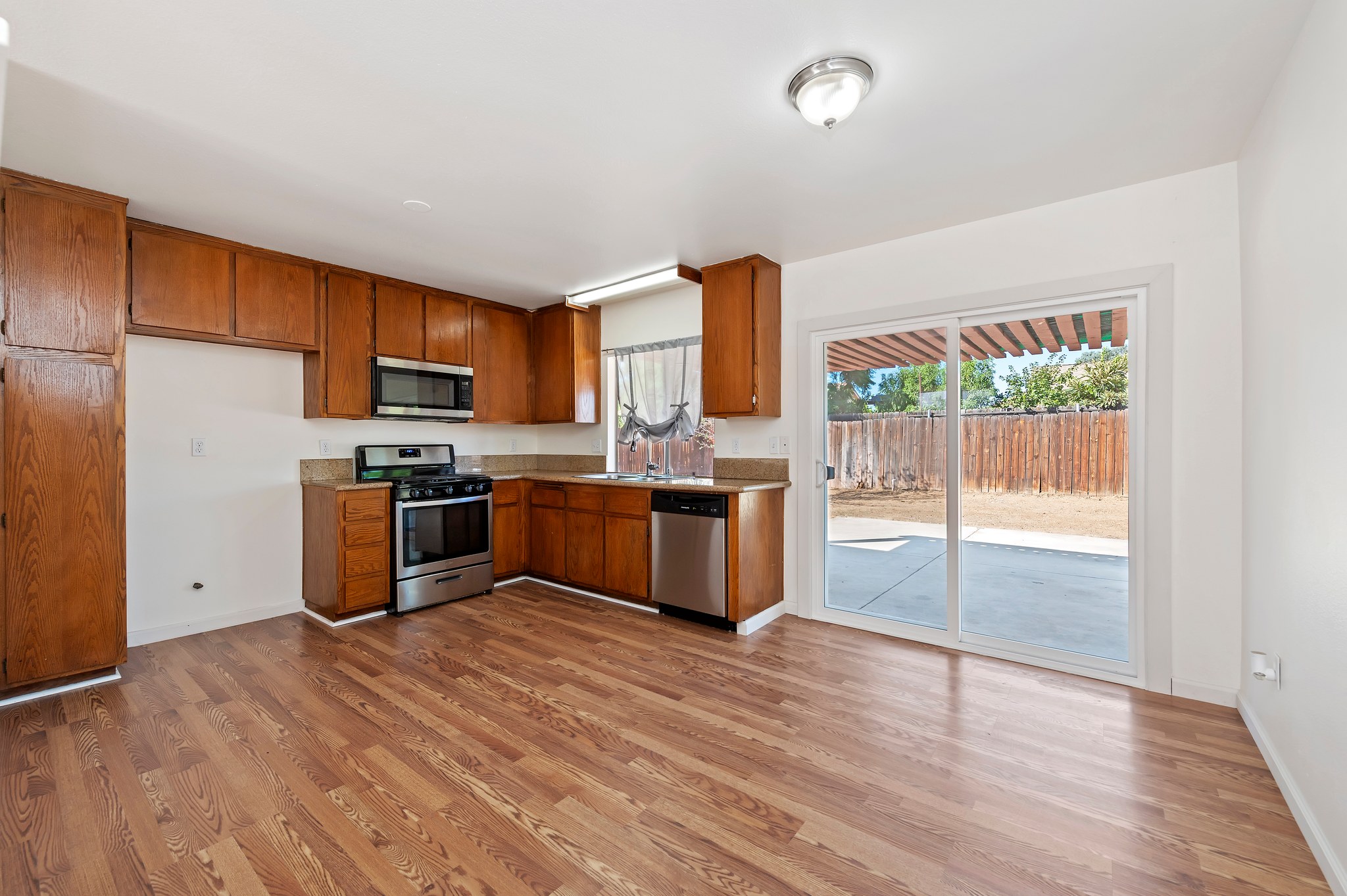 Kitchen with stainless appliances and sliding door to the patio | 14927 Wintergreen St, Moreno Valley