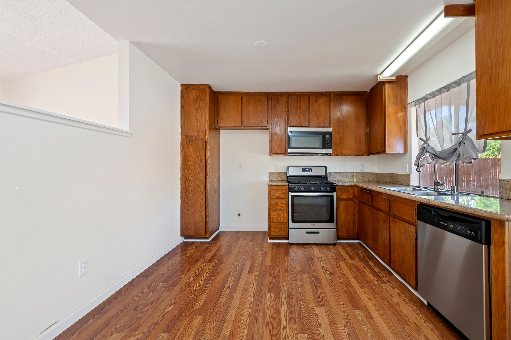 Kitchen with stainless steel gas range, microwave and dishwasher | 14927 Wintergreen St, Moreno Valley