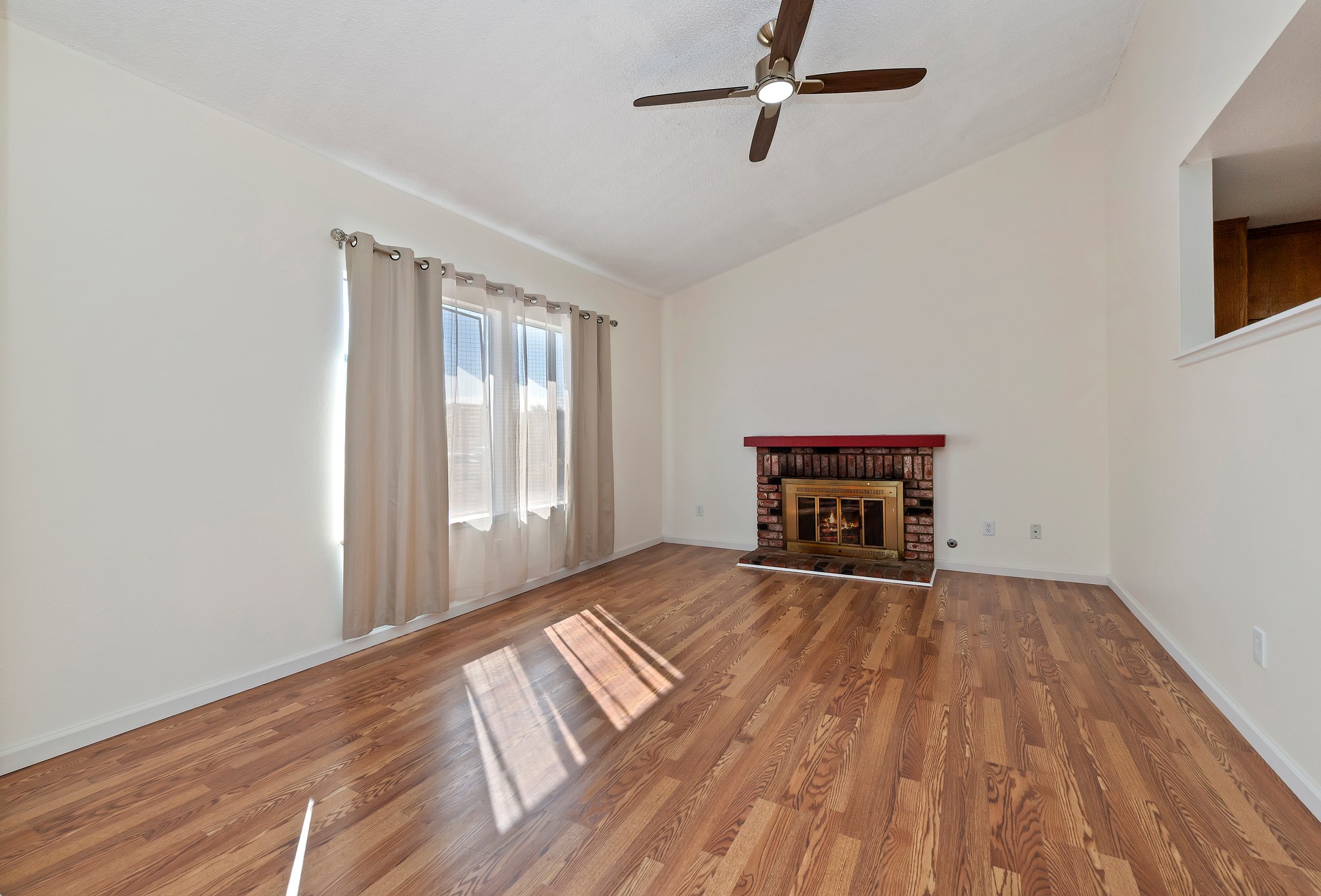 Living room with vaulted ceiling and ceiling fan | 14927 Wintergreen St, Moreno Valley