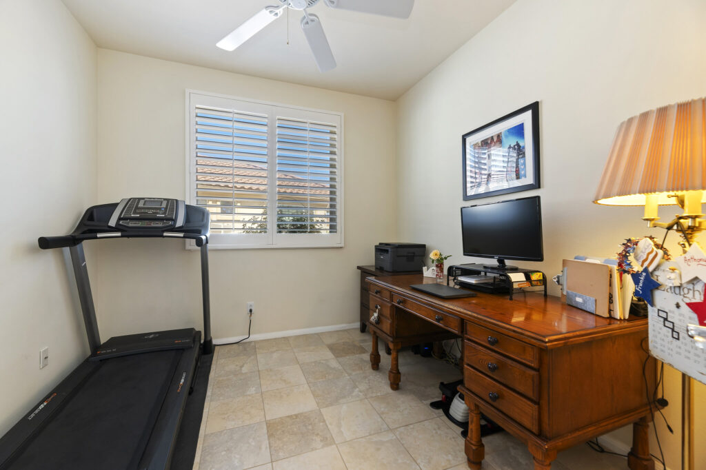 1142 Wisteria Way, Beaumont — den with plantation shutters and ceiling fan