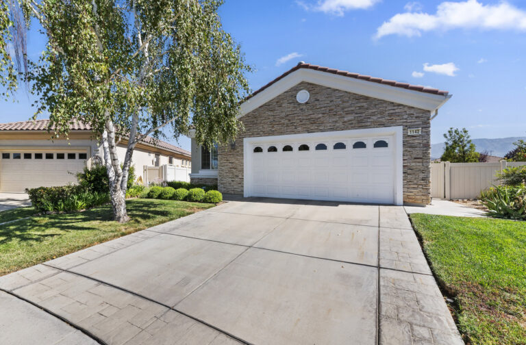1142 Wisteria Way, Beaumont — front exterior with two-car garage and stacked-stone facade