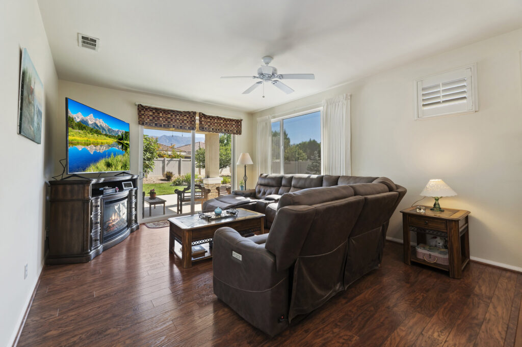 1142 Wisteria Way, Beaumont — living room with ceiling fan and wood-look flooring