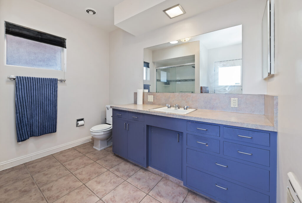 1717 Terrace Dr, Hemet — bathroom with blue vanity and tile floor