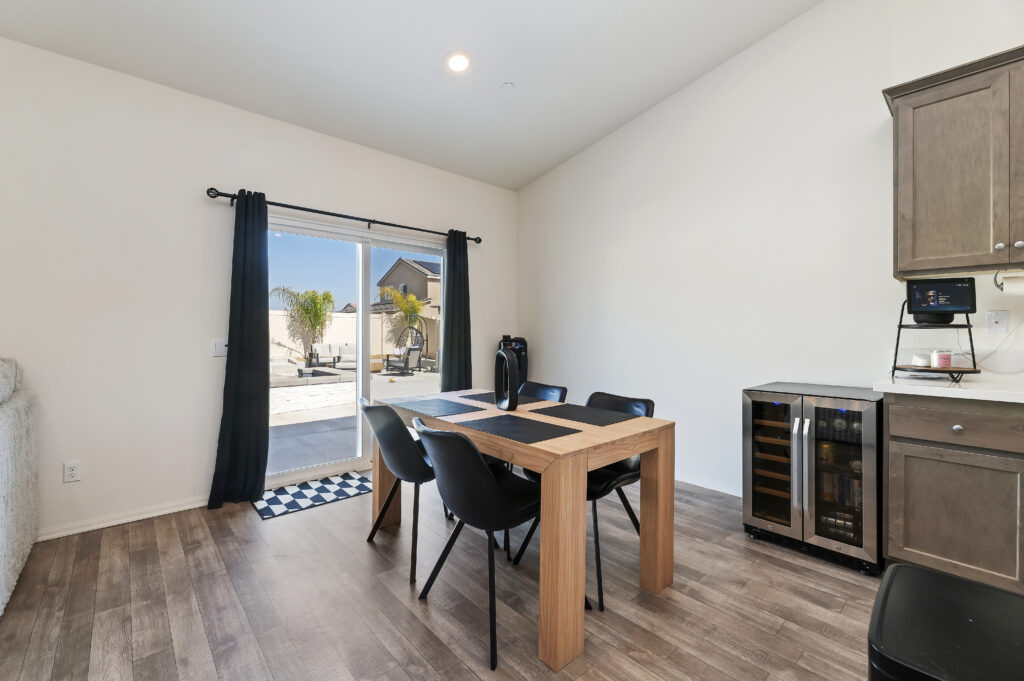 2153 El Nido Ave, Perris — dining area with wine fridge and sliding door to the pool deck