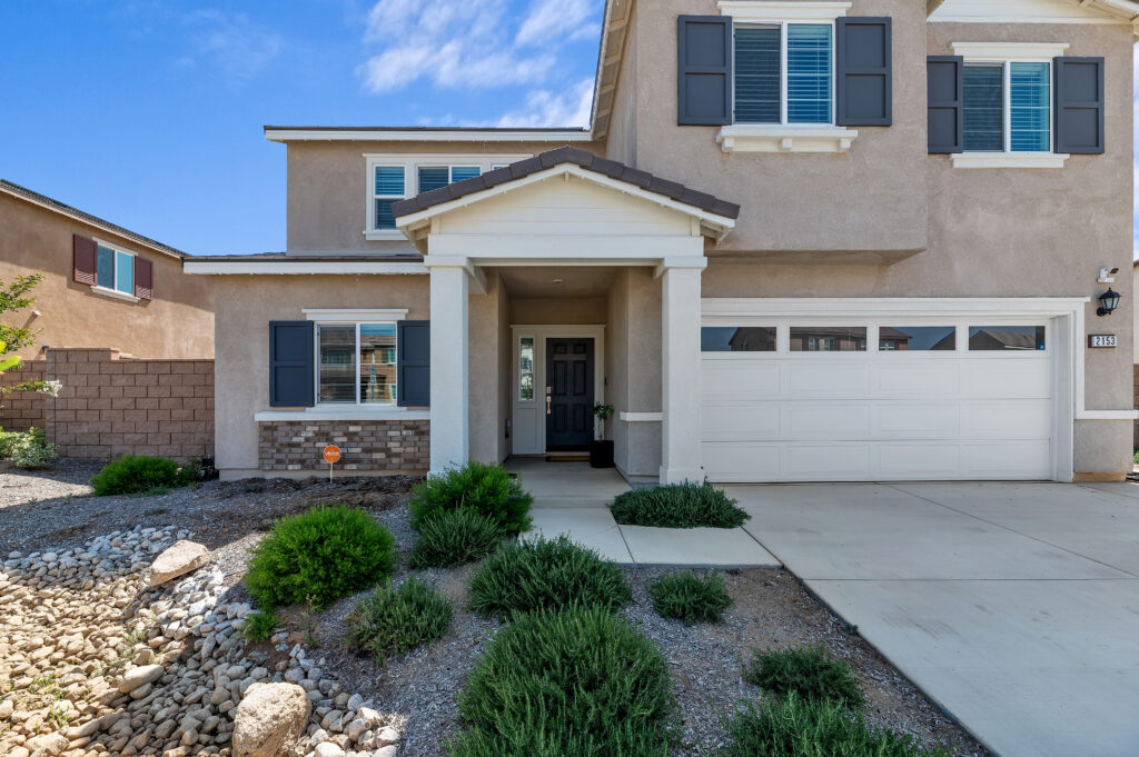 2153 El Nido Ave, Perris — covered front porch, stone accents and two-car garage