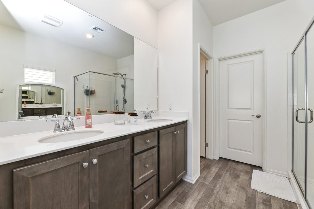 2153 El Nido Ave, Perris — primary bathroom with double vanity, quartz counter and walk-in shower