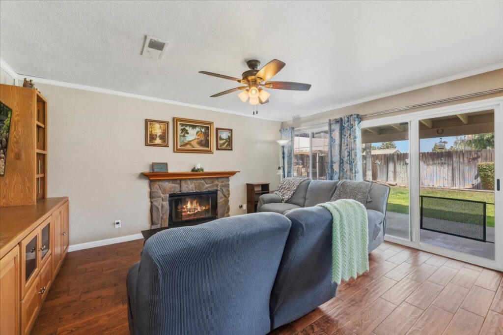 42138 Bancroft Way, Hemet — family room with stone fireplace and sliding doors to the yard