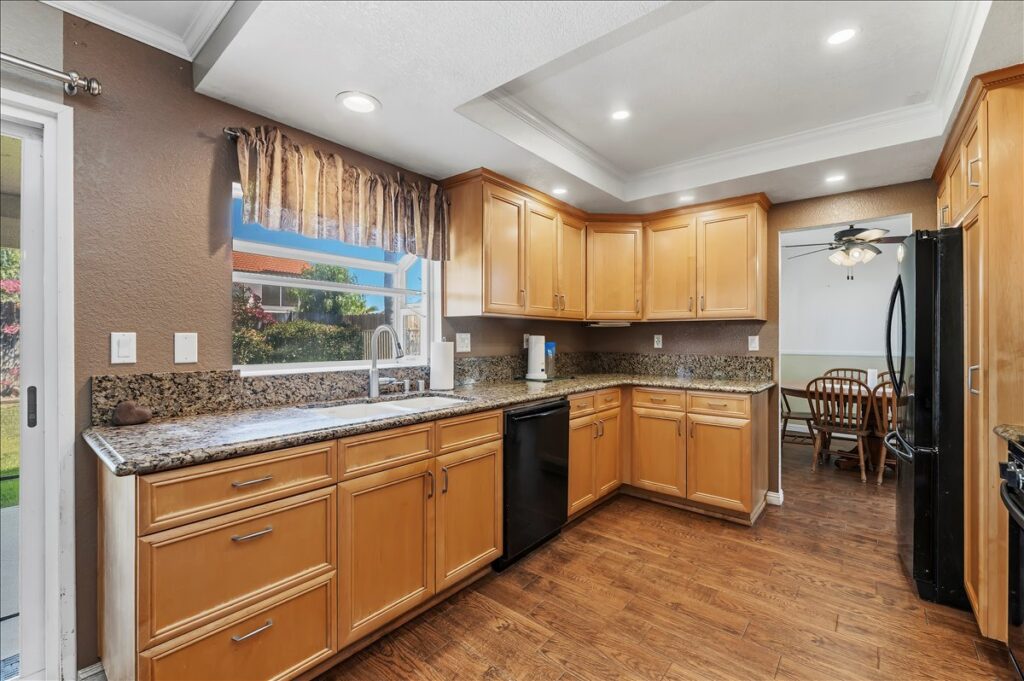 42138 Bancroft Way, Hemet — kitchen with granite counters and wood cabinetry
