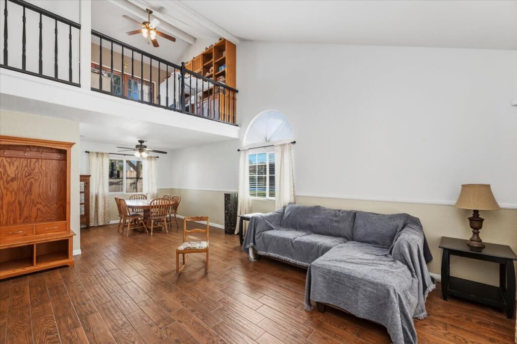 42138 Bancroft Way, Hemet — living and dining room with wood-look floors and loft above