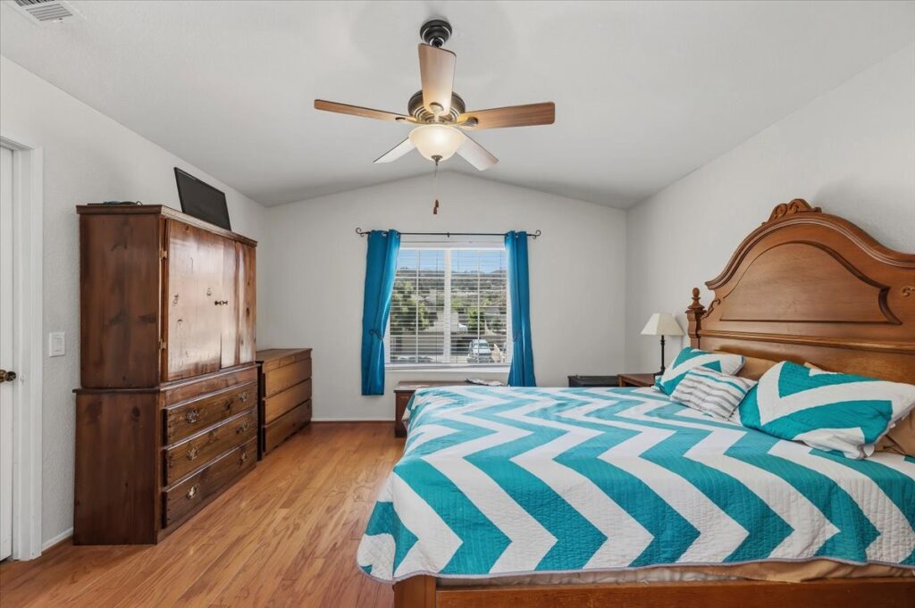 42138 Bancroft Way, Hemet — primary bedroom with vaulted ceiling and ceiling fan