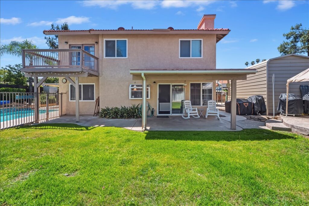 42138 Bancroft Way, Hemet — rear of the home with lawn, covered patio and loft balcony