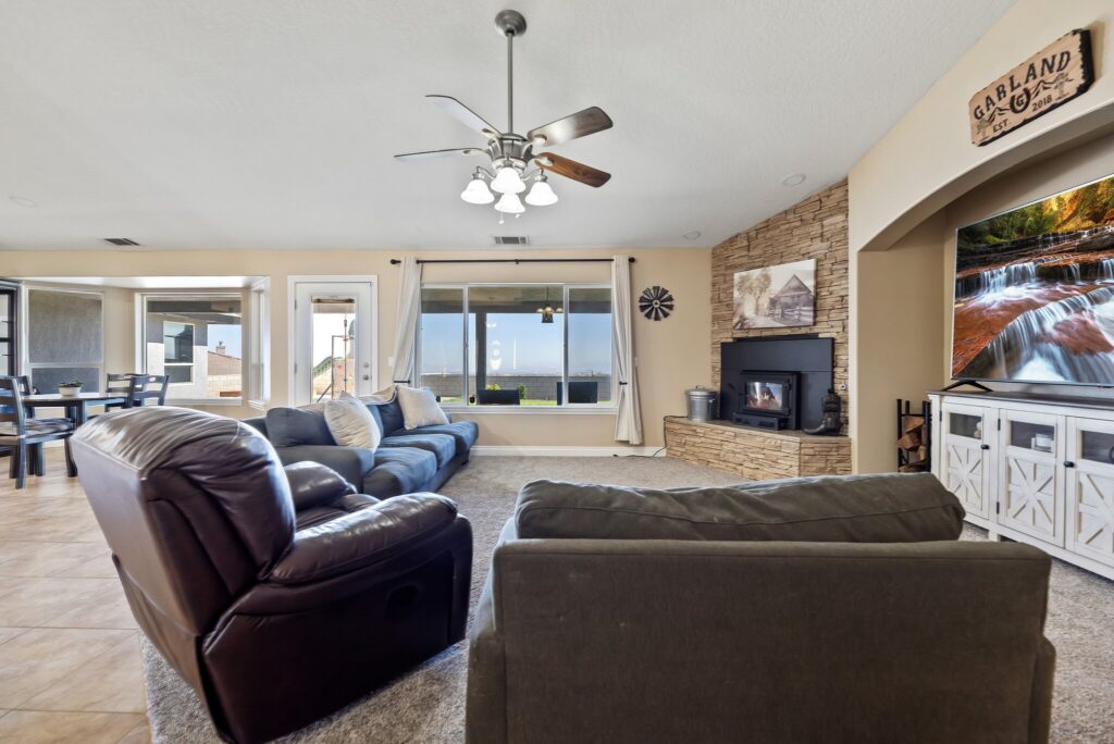 7122 Braceo St, Oak Hills — family room with stone-surround stove
