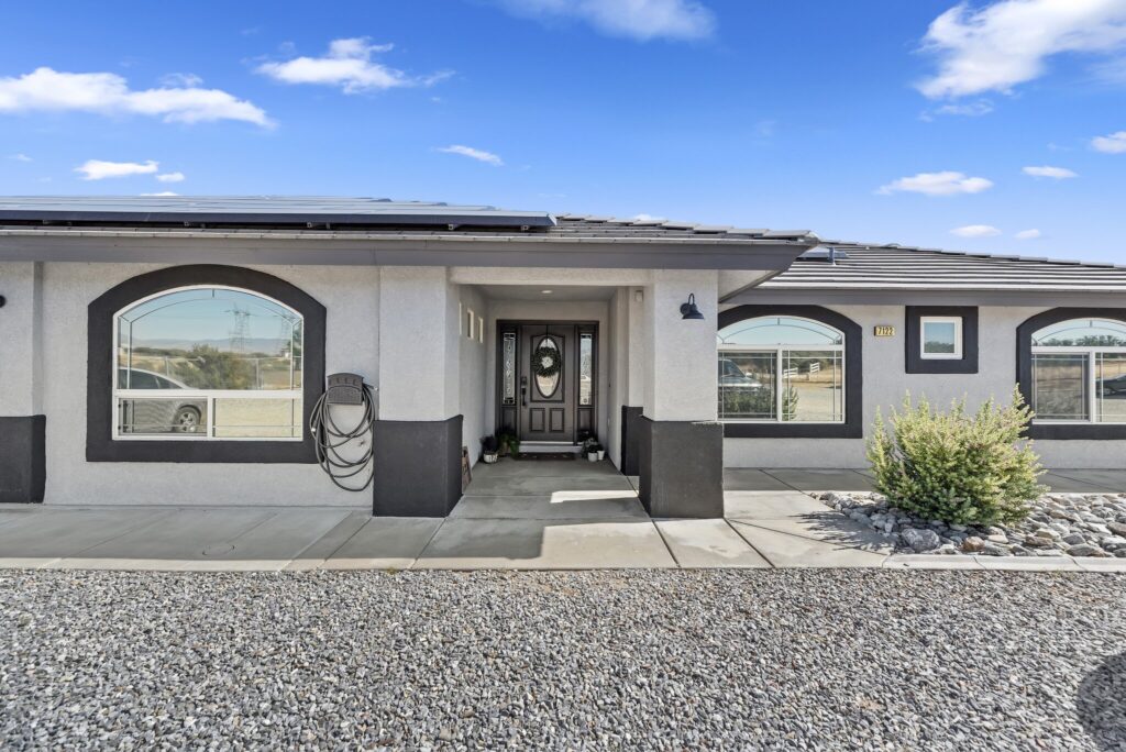 7122 Braceo St, Oak Hills — front entry with arched windows and solar panels